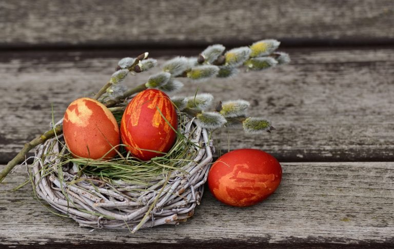 Ostern - Dekoration mit roten Ostereiern und Palmzweig